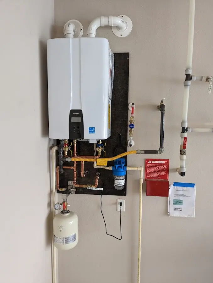 Professional plumber installing copper piping in a Woodlake home